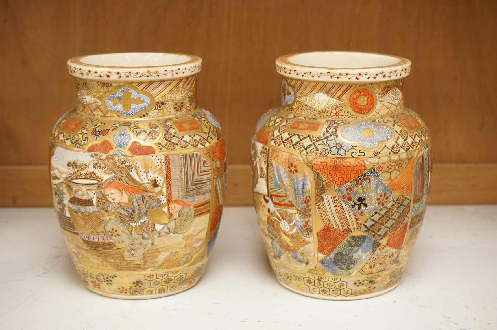 A pair of Japanese Satsuma 'Boys' vases, Meiji period, 17.5cm